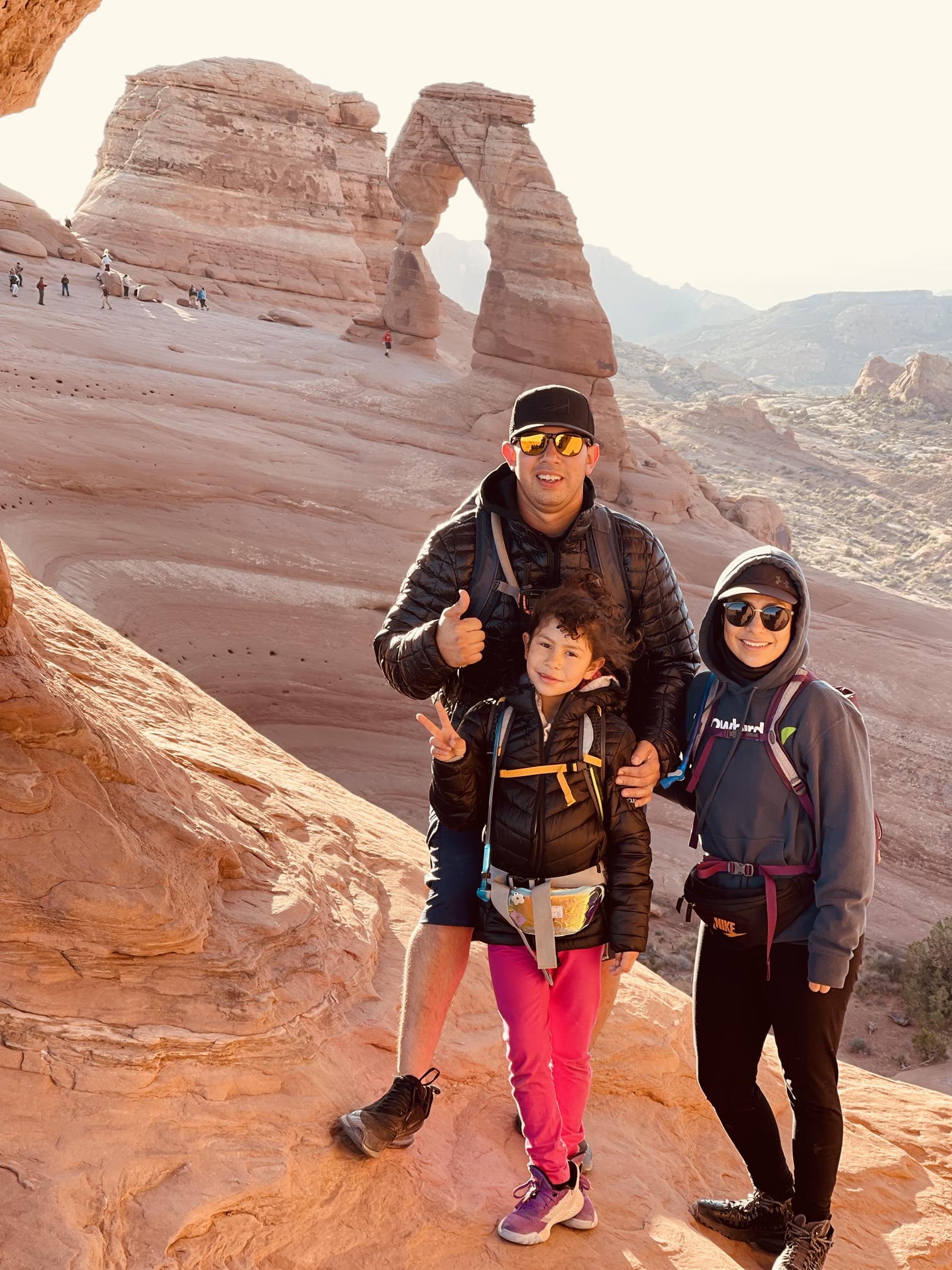 my wife, daughter and i at the arches in moab utah